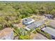 Aerial view of the property highlighting the fenced yard and landscaping in a lush setting at 1322 Idlewild Dr, Clearwater, FL 33755
