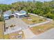 Aerial view showcasing the property with a fenced yard, tropical landscaping, and parking at 1322 Idlewild Dr, Clearwater, FL 33755