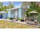 Cozy backyard with a light blue shed, a lounge chair, and an outdoor seating area with umbrella at 1322 Idlewild Dr, Clearwater, FL 33755
