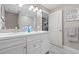 Modern bathroom with double vanity, tiled floors, and updated fixtures at 1322 Idlewild Dr, Clearwater, FL 33755