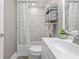 Clean bathroom featuring a shower-tub combination, sleek vanity and stylish shelving at 1322 Idlewild Dr, Clearwater, FL 33755