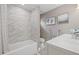 Well-lit bathroom with marble tiled shower/tub and double vanity at 1322 Idlewild Dr, Clearwater, FL 33755
