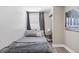 Cozy bedroom featuring a patterned accent wall and gray furnishings at 1322 Idlewild Dr, Clearwater, FL 33755