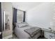 Comfortable bedroom featuring a mirror, patterned accent wall and a work table at 1322 Idlewild Dr, Clearwater, FL 33755