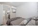 Modern bedroom featuring geometric accent wall, sleek furnishings, and adjacent kitchenette at 1322 Idlewild Dr, Clearwater, FL 33755