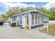Charming cottage exterior with vibrant blue siding and ample parking space at 1322 Idlewild Dr, Clearwater, FL 33755