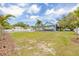 Charming light blue home with a spacious backyard and well-maintained white fence, under a sunny sky at 1322 Idlewild Dr, Clearwater, FL 33755