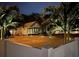 Night view of a charming building with palm trees, parking, and exterior lighting at 1322 Idlewild Dr, Clearwater, FL 33755