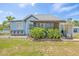 Cozy home with a screened porch, adorned with blooming plants, inviting outdoor charm and curb appeal at 1322 Idlewild Dr, Clearwater, FL 33755