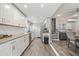 Bright kitchen featuring white cabinets, stainless steel appliances, and an eat-in dining area at 1322 Idlewild Dr, Clearwater, FL 33755