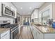 Modern kitchen with white cabinetry, stainless steel appliances, and granite countertops at 1322 Idlewild Dr, Clearwater, FL 33755