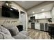 Compact kitchen with white cabinets, stainless steel appliances, and open layout, adjacent to living area at 1322 Idlewild Dr, Clearwater, FL 33755