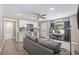 Open-concept living area with a modern kitchen, cozy couch, and dining space, with natural light at 1322 Idlewild Dr, Clearwater, FL 33755