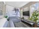 Bright living room featuring a large palm tree wall hanging and entertainment area at 1322 Idlewild Dr, Clearwater, FL 33755