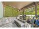 Relaxing covered porch with comfortable seating, fan, and greenery, perfect for outdoor enjoyment at 1322 Idlewild Dr, Clearwater, FL 33755