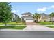 Inviting two-story home featuring a manicured lawn and an attached two-car garage and a paved driveway at 13876 Stansil Ave, Odessa, FL 33556