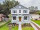 Beautiful two-story home with professionally landscaped yard, stone accents, shutters, and charming front porch at 1526 W Arch St, Tampa, FL 33607