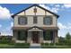 Charming two-story home with stone accents, neutral siding, shutters, covered porch, and professionally landscaped yard at 1526 W Arch St, Tampa, FL 33607