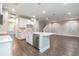 Open-concept kitchen with island, stainless steel dishwasher, white cabinetry, and hardwood floors at 1526 W Arch St, Tampa, FL 33607