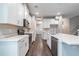 Modern kitchen featuring stainless steel appliances, white cabinetry, quartz countertops, and hardwood floors at 1526 W Arch St, Tampa, FL 33607