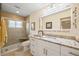 Bright bathroom featuring granite countertops, tiled shower, and decorative mirror at 1666 S Lake Ave # 1, Clearwater, FL 33756