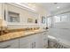 Bathroom featuring a vanity with granite countertop and glass-enclosed shower at 1666 S Lake Ave # 1, Clearwater, FL 33756