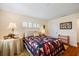 Comfortable bedroom featuring wood floors, shutters, and a decorative quilt at 1666 S Lake Ave # 1, Clearwater, FL 33756