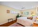 Well-lit bedroom with a ceiling fan, hardwood floors and plantation shutters at 1666 S Lake Ave # 1, Clearwater, FL 33756
