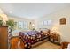 Comfortable bedroom features hardwood floors, plantation shutters, and stylish furnishings at 1666 S Lake Ave # 1, Clearwater, FL 33756