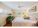 Inviting bedroom with shutters, wood floors and white bedding with decorative pillows at 1666 S Lake Ave # 1, Clearwater, FL 33756