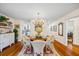 Dining room with chandelier, wood floors, and white wicker chairs at 1666 S Lake Ave # 1, Clearwater, FL 33756