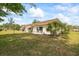 Relaxing home exterior with beautiful landscaping, a well-maintained lawn, and an outdoor seating area at 1666 S Lake Ave # 1, Clearwater, FL 33756