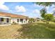 Inviting home exterior with a lush lawn, mature trees, and a relaxing outdoor seating area at 1666 S Lake Ave # 1, Clearwater, FL 33756