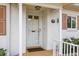 Inviting front entrance of white brick home with tiled porch and well-kept garden at 1666 S Lake Ave # 1, Clearwater, FL 33756