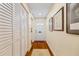 Bright hallway featuring hardwood floors, a white door and white closet doors at 1666 S Lake Ave # 1, Clearwater, FL 33756
