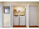 Convenient laundry closet with washer, dryer, and storage shelving at 1666 S Lake Ave # 1, Clearwater, FL 33756