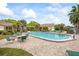 Inviting community pool surrounded by comfortable lounge seating and lush tropical landscaping at 1666 S Lake Ave # 1, Clearwater, FL 33756