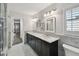 Bright bathroom with marble counters, dual sinks and lots of storage at 17 Bellevue Dr, Treasure Island, FL 33706