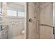 Well-lit bathroom with shower and window with shutters at 17 Bellevue Dr, Treasure Island, FL 33706