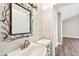 Stylish powder room with a decorative mirror and modern fixtures at 17 Bellevue Dr, Treasure Island, FL 33706