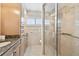 Bright bathroom features granite countertops, shower, and a window with shutters at 17 Bellevue Dr, Treasure Island, FL 33706