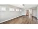Bright bedroom with wood floors and three windows with white shutters at 17 Bellevue Dr, Treasure Island, FL 33706