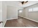 Bright bedroom featuring wood-look flooring, mirrored closet, and window with plantation shutters at 17 Bellevue Dr, Treasure Island, FL 33706