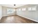 Cozy bedroom with wood floors and three windows with white shutters at 17 Bellevue Dr, Treasure Island, FL 33706
