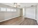 Bedroom with gray walls, hardwood floors, three plantation shutter windows, closet and ensuite access at 17 Bellevue Dr, Treasure Island, FL 33706