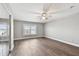 A bright bedroom with wood-look floors, white trim and ceiling fan at 17 Bellevue Dr, Treasure Island, FL 33706