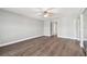 Bright bedroom showcases wood-look flooring and neutral paint with a ceiling fan at 17 Bellevue Dr, Treasure Island, FL 33706