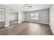Large bedroom with wood floors and mirrored closet at 17 Bellevue Dr, Treasure Island, FL 33706