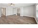 Open bedroom features wood-look floors and mirrored closet at 17 Bellevue Dr, Treasure Island, FL 33706