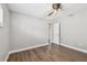 A bedroom with wood-look floors and doorway with a door ajar at 17 Bellevue Dr, Treasure Island, FL 33706